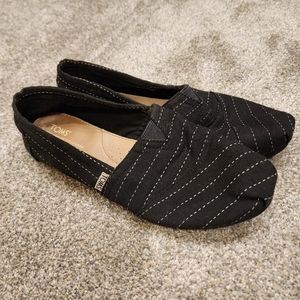 Toms black and white slip ons